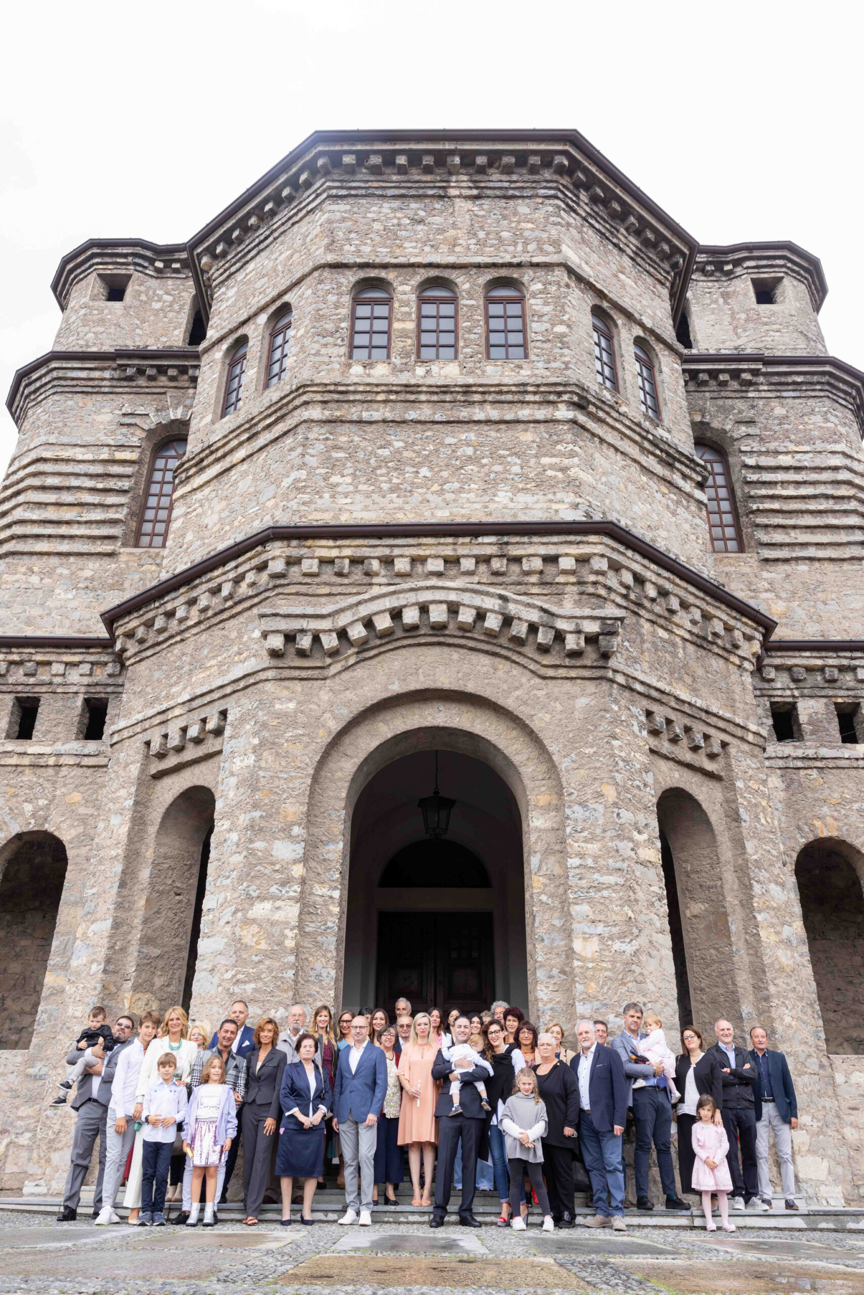 Foto di famiglia dopo il battesimo fuori la parrocchia di comenduno